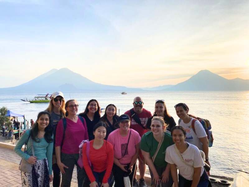 V.C.U. nursing students with faculty Amy Burlar and Mary Falk pose for a photo by Lake Atitlán in Guatemala